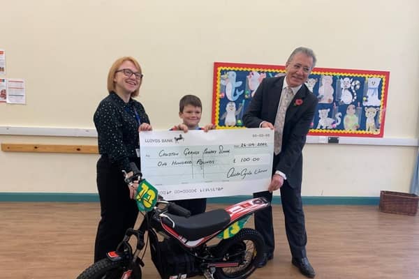 Toby Cossar with Kate Worthington, Headteacher at Cawston Grange Primary School, and Mark Pawsey MP.