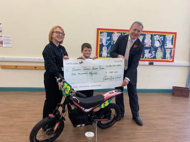 Toby Cossar with Kate Worthington, Headteacher at Cawston Grange Primary School, and Mark Pawsey MP.