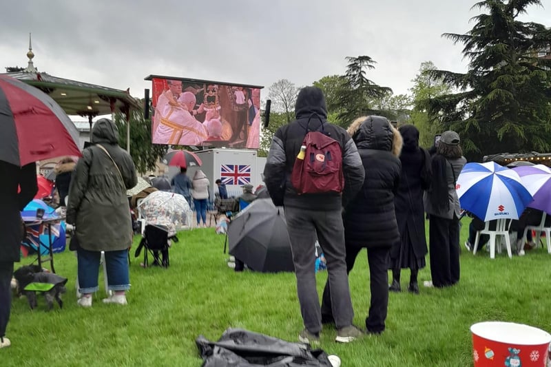Residents braved the rain to watch the Coronation on the big scree at the Pump Room Gardens on Saturday.