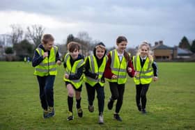 Paddox Primary School's cross-country club running in their donated vests