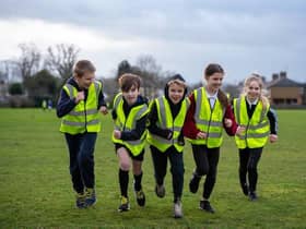 Paddox Primary School's cross-country club running in their donated vests