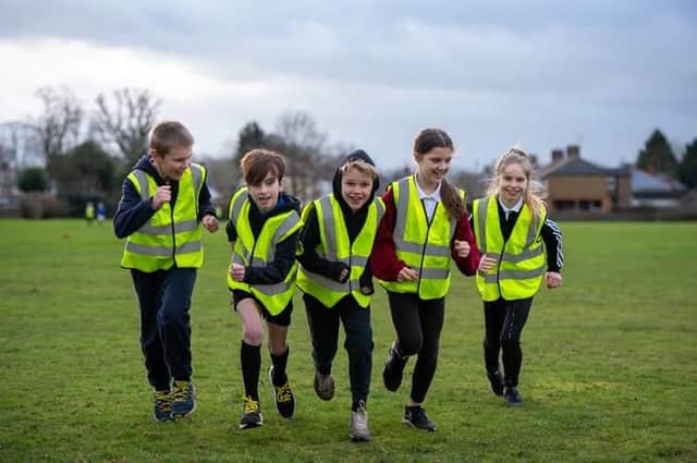 Paddox Primary School's cross-country club running in their donated vests