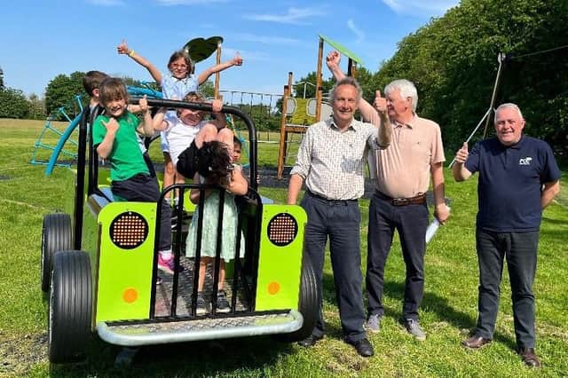 Bubbenhall children celebrate the new playground with Jan Lucas, outgoing chair of Bubbenhall Parish Council and representatives from funders FCC Communities Foundation and Segro.