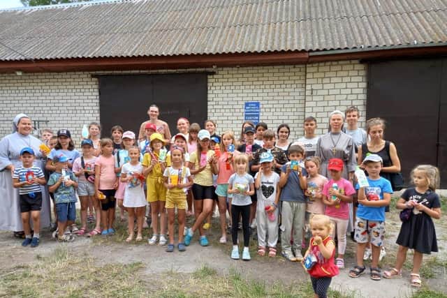 The children in Lubar gather together showing the donations received from The Polish Centre. Picture supplied.