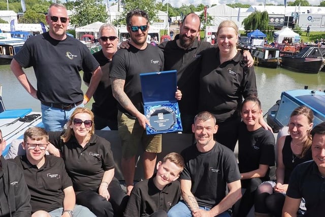 The Bespoke Boat Company team with the trophy for Favourite Widebeam at Crick Boat Show  2024 on the roof deck of their winning boat Lunar.