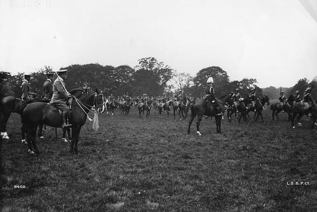 An army review takes place at Warwick Castle circa 1909.