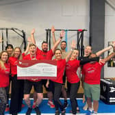 Martin Browne is pictured with members of Physical Formula and gym co-founder Olivia Kreigenfeld (front second from right) holding the cheque for £7,567 which they gave to The Myton Hospices after raising the money by conquering the Goggins Challenge.
