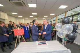 Saqib Bhatti MP shaking hands with Stuart Croft after a ceremonial cutting of cake