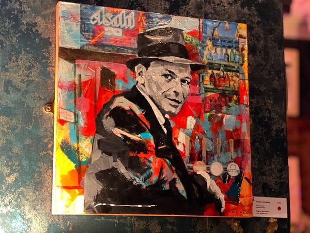 One of Rupam Barthakur's paintings in Ronnie's Bar. Photo by Alex Harvey of RiVR