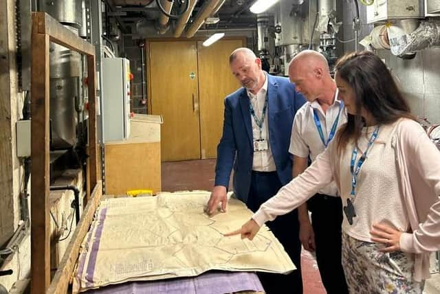 Right to left: Cristina Calleja, Sustainability Manager, pictured with colleagues Mark Wise, Senior Estates Manager, and Nigel Corcoran, Head of Estates, reviewing plans to decarbonise the Warwick Hospital site. Photo supplied