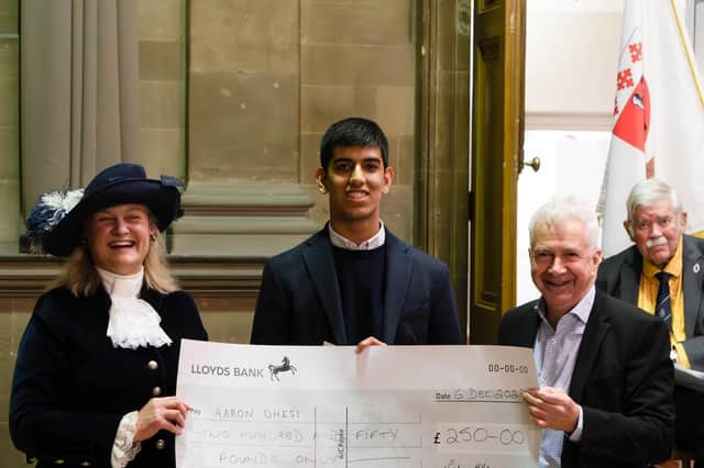 Aaron Dhesi with his winner's cheque.