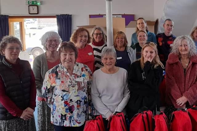 Volunteers with the filled 'buddy bags' for children in emergency situations.