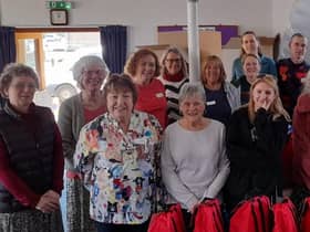 Volunteers with the filled 'buddy bags' for children in emergency situations.