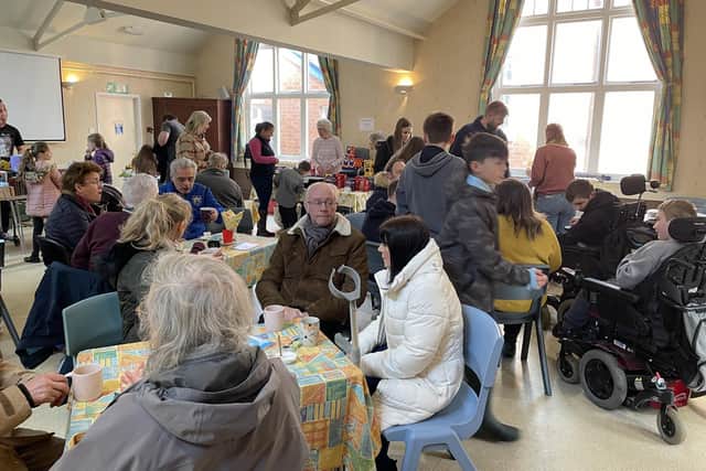 Crowds enjoying the Fete in the church hall.