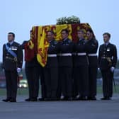 Pallbearers from the Queen's Colour Squadron (63 Squadron RAF Regiment) carry the coffin of Queen Elizabeth II to the Royal Hearse having removed it from the C-17 at the Royal Air Force Northolt airbase on September 13, 2022 in London.
