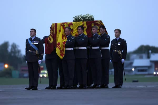 Pallbearers from the Queen's Colour Squadron (63 Squadron RAF Regiment) carry the coffin of Queen Elizabeth II to the Royal Hearse having removed it from the C-17 at the Royal Air Force Northolt airbase on September 13, 2022 in London.