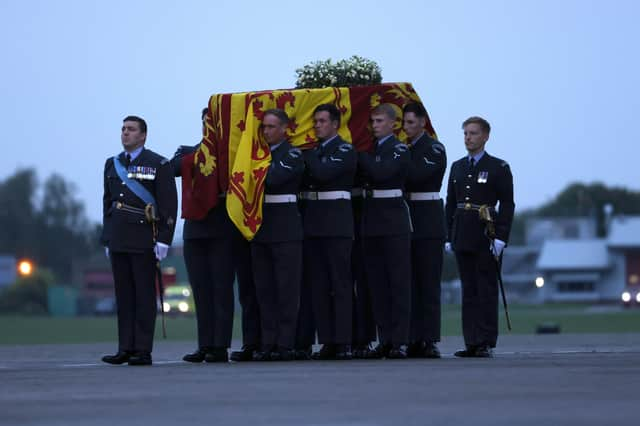 Pallbearers from the Queen's Colour Squadron (63 Squadron RAF Regiment) carry the coffin of Queen Elizabeth II to the Royal Hearse having removed it from the C-17 at the Royal Air Force Northolt airbase on September 13, 2022 in London.