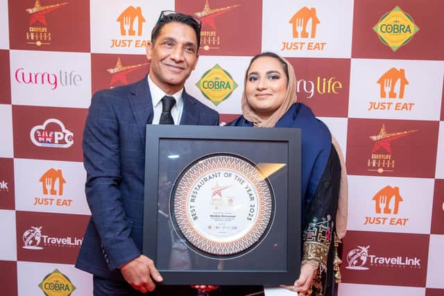 Iftehar Ahmed and Iftahara Ahmed collect the award for Bombay in the Best Restaurant category at The Curry Life Awards 2023. Picture supplied.