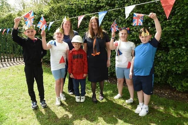 Bellway sales advisor Patricia Aaron and Lighthorne Heath community champion Emma Hills, with Lighthorne Heath Primary School pupils at the school’s summer event, which was supported by Bellway. Photo supplied