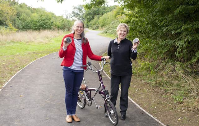 Alison Kennedy, principal transport planner at Warwickshire County Council, and Cllr Kathryn Lawrence, Rugby Borough Council portfolio holder for operations and traded services, inspect the 'Bat Hat' solar-powered lights used on the Park Connector Network expansion.