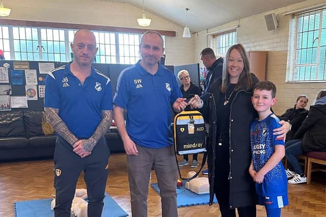 Naomi presents the equipment to Long Lawford football players