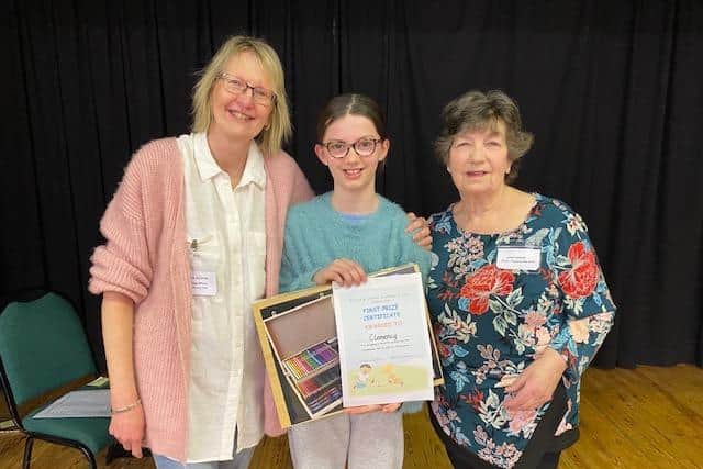 Debbie Gulliver ( Booking Officer and Committee member) and Janet Malin ( Chair and trustee) with the winner of the logo competition Clemmy.