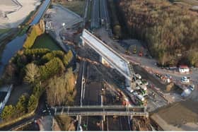 A 12,600 tonne bridge has slid into place over the M42 in Warwickshire, in what engineers are describing as a 'world first'.