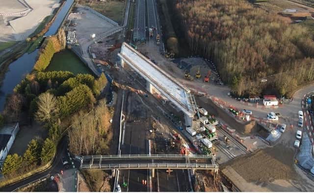 A 12,600 tonne bridge has slid into place over the M42 in Warwickshire, in what engineers are describing as a 'world first'.