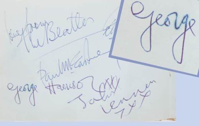 The Beatles autographs with a blurry 'George' inset.
