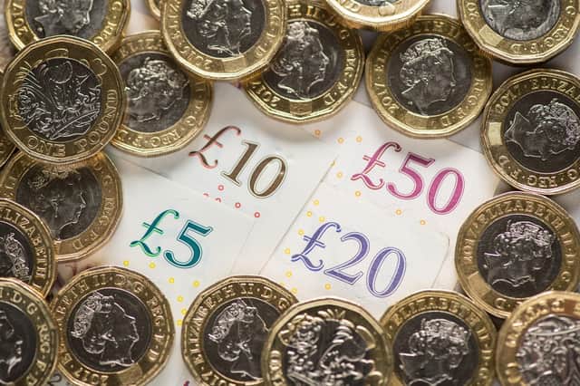EMBARGOED TO 0001 FRIDAY OCTOBER 14 File photo dated 26/01/18 of a UK five pound, ten pound, twenty pound and fifty pound notes with one pound coins, as city bonuses have increased at more than twice the speed of wages since the 2008 financial crash, research suggests.