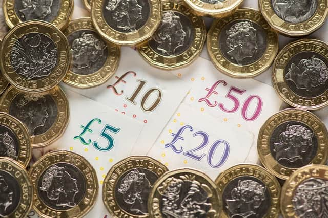 EMBARGOED TO 0001 FRIDAY OCTOBER 14 File photo dated 26/01/18 of a UK five pound, ten pound, twenty pound and fifty pound notes with one pound coins, as city bonuses have increased at more than twice the speed of wages since the 2008 financial crash, research suggests.