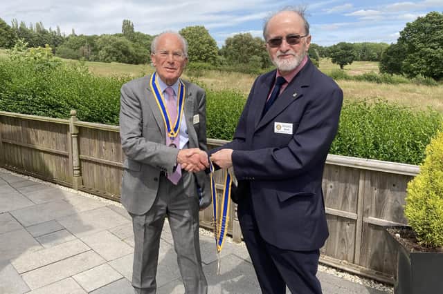 Michael Heath (at right) hands over his Rotary Club of Royal Leamington Spa presidency to David Leigh-Hunt. Picture submitted.