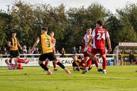 George Ward (on the ground) sees his volley fly in against Scarborough. Photo: Cameron Murray.