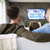 A family enjoy TV together