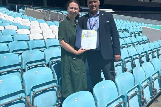 Jugjit Chima, chief executive officer of the National Association of Examinations Officers, presents the award to Jade Hussey of Trinity Catholic School.