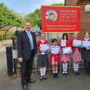 Mr Costa is pictured with pupils from Swinford CofE Primary School and Coronation card competition winner, Agatha Leuzy-Hall (centre) and Rachel Chamberlain, co-headteacher.