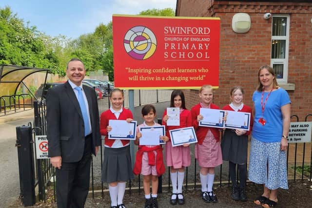 Mr Costa is pictured with pupils from Swinford CofE Primary School and Coronation card competition winner, Agatha Leuzy-Hall (centre) and Rachel Chamberlain, co-headteacher.