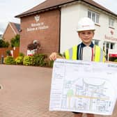 Harry, nine, shows off his winning design.