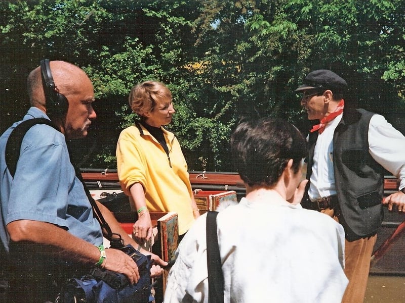 David Suchet pictured with TV presenter Pam Rhodes, filming BBC’s Songs of Praise on the steamboat President at the 1999 Braunston Boat Show.