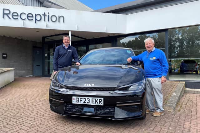 Richard Roberts (left), dealership principal at Startin Kia – Warwick, and Barry Andrews, chairman of Leamington Rotary Club’s fundraising committee, with a Kia EV electric car.