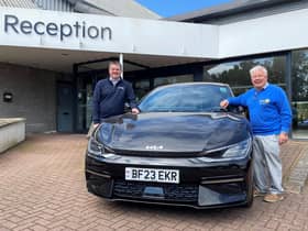 Richard Roberts (left), dealership principal at Startin Kia – Warwick, and Barry Andrews, chairman of Leamington Rotary Club’s fundraising committee, with a Kia EV electric car.