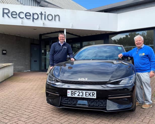 Richard Roberts (left), dealership principal at Startin Kia – Warwick, and Barry Andrews, chairman of Leamington Rotary Club’s fundraising committee, with a Kia EV electric car.