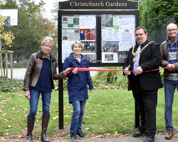 Mayor Nick Wilkins cuts the ribbon to celebrate the installation of the public noticeboard in Christchurch Gardens.  Friends of Christchurch Gardens members Jenny and Paul Dickins attended along with Chair Alison Chantrey. Photo credit: David Chantrey.