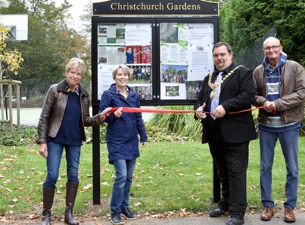 Mayor Nick Wilkins cuts the ribbon to celebrate the installation of the public noticeboard in Christchurch Gardens.  Friends of Christchurch Gardens members Jenny and Paul Dickins attended along with Chair Alison Chantrey. Photo credit: David Chantrey.