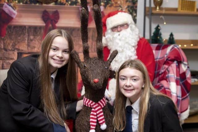 Sophie Green and Ravin Williams enjoy seeing Santa Claus.