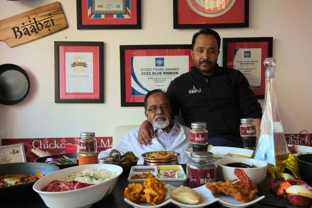 Baabzi Miah (right) with his father inside the takeaway in Coten End in Warwick. Photo supplied