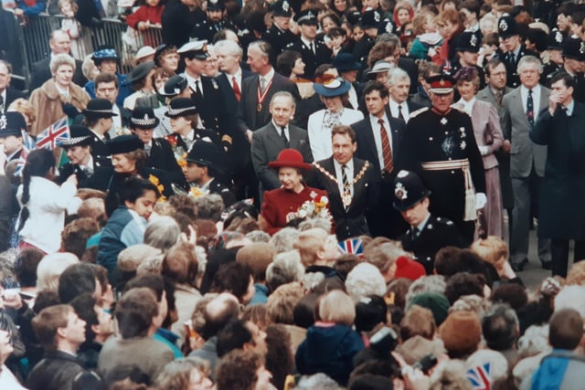 Crowds gather to greet the Queen