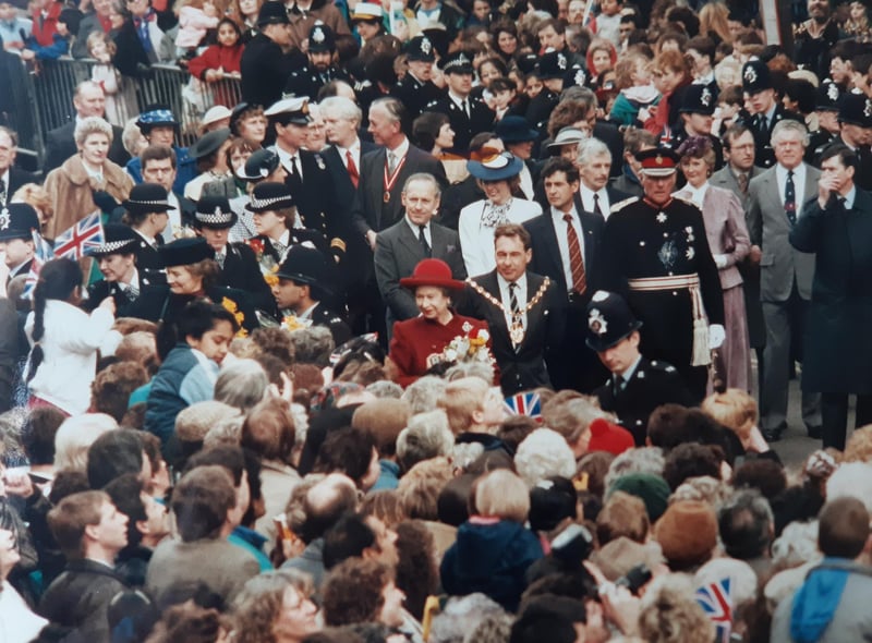 Crowds gather to greet the Queen