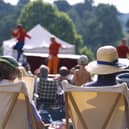 View from behind two visitors seated in deckchairs as part of the audience at the Illyria Theatre Company's production of Ali Baba & the Forty Thieves at Dudmaston. M.R.