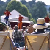 View from behind two visitors seated in deckchairs as part of the audience at the Illyria Theatre Company's production of Ali Baba & the Forty Thieves at Dudmaston. M.R.